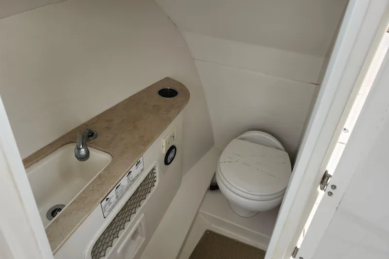 Slide: The Image of Interior of 2017 Sailfish 275 DC boat bathroom with sink and toilet. - 24