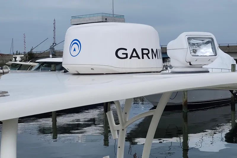 Slide: The Image of 2017 Sailfish 275 DC boat with Garmin radar and spotlight, docked at marina. - 25