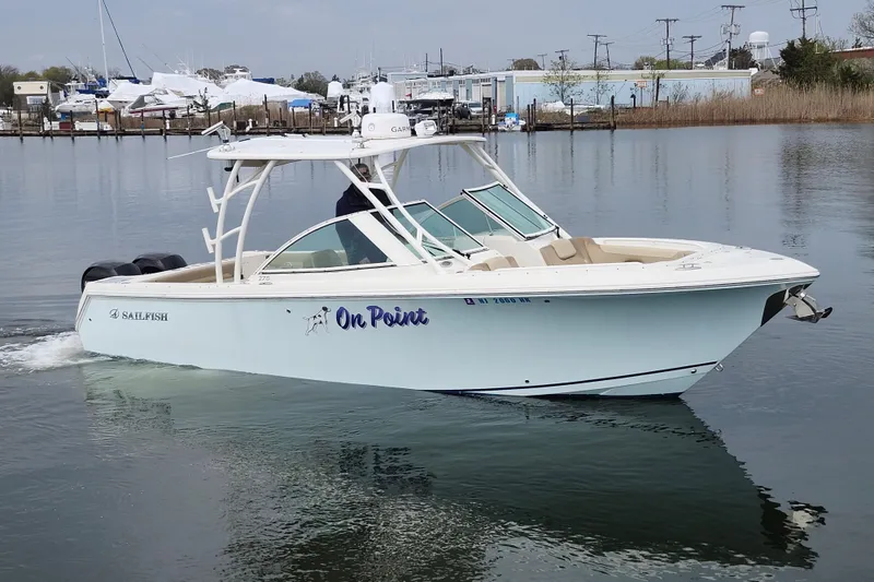 Slide: The Image of 2017 Sailfish 275 DC boat on calm water, featuring sleek design and dual engines. - 8