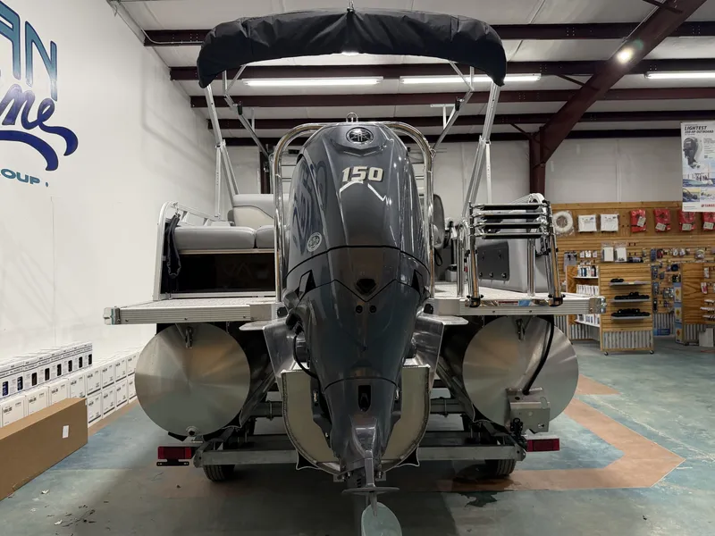 Slide: The Image of Avalon VNT VRB21T 2026 pontoon boat with outboard motor in showroom. - 3