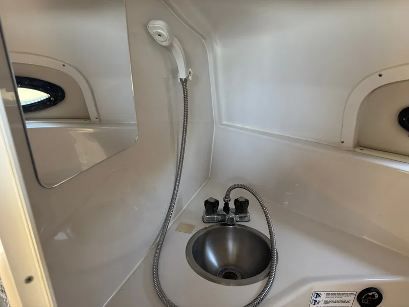 Slide: The Image of Interior of 1999 Four Winns 258 Vista with sink and shower. - 12