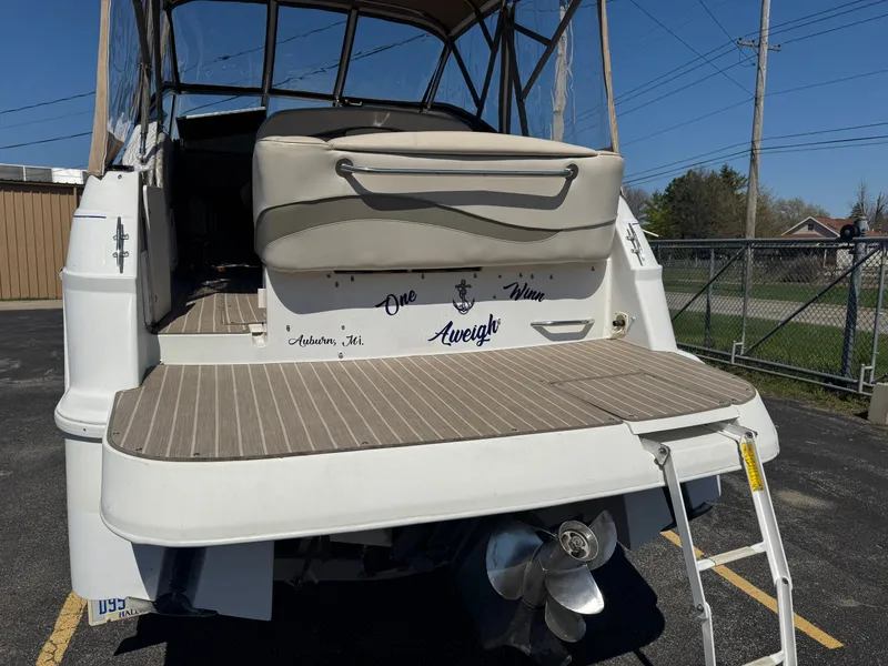 Slide: The Image of 1999 Four Winns 258 Vista boat with platform and ladder. - 15