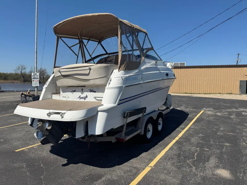 Slide: The Image of 1999 Four Winns 258 Vista boat parked on trailer outdoors. - 2