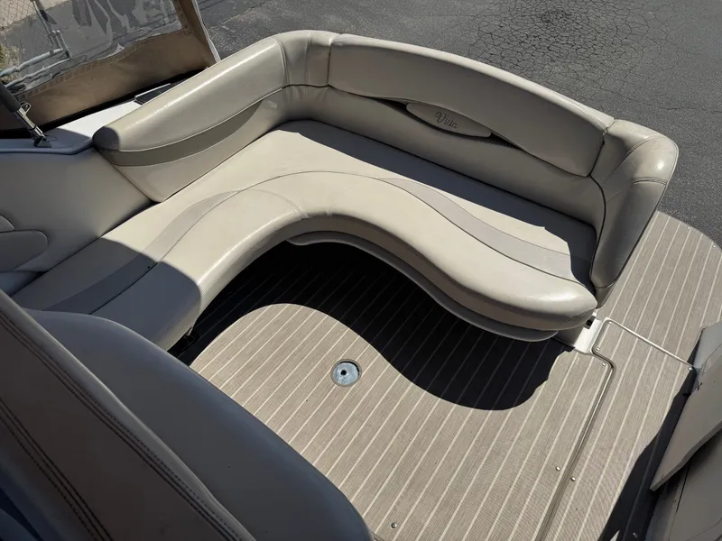 Slide: The Image of Interior of a 1999 Four Winns 258 Vista boat with curved seating. - 5