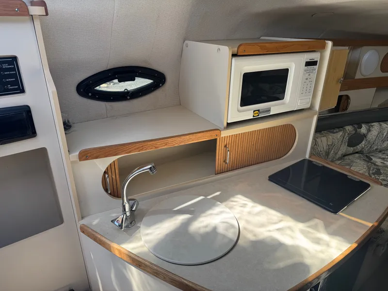 Slide: The Image of Interior of 1999 Four Winns 258 Vista with kitchenette and microwave. - 7