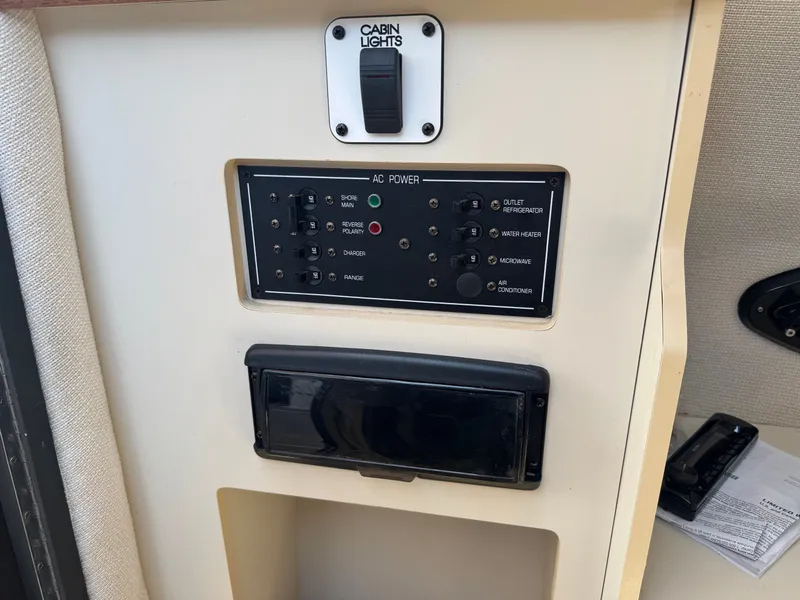 Slide: The Image of Control panel of 1999 Four Winns 258 Vista with switches and indicators. - 8