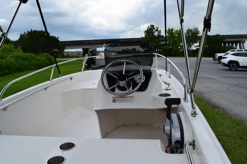 Slide: The Image of The image shows the cockpit of a 2026 Boston Whaler 130 Super Sport with a clear steering area. - 4
