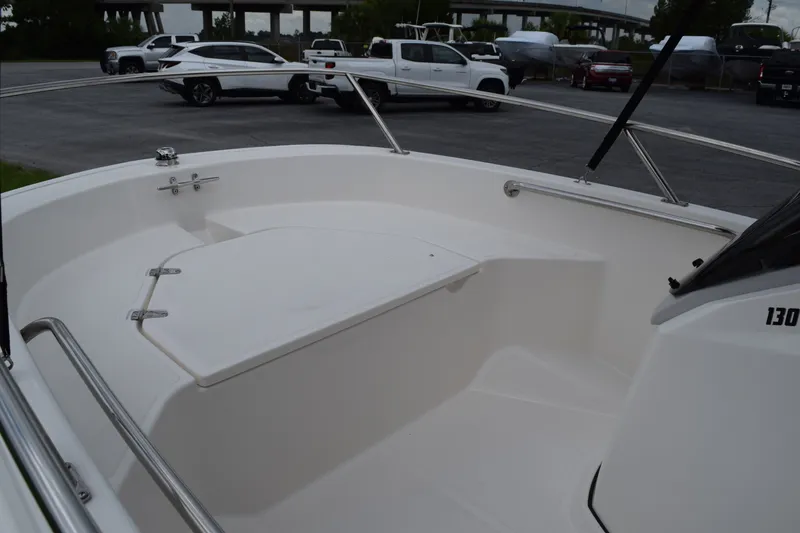 Slide: The Image of The image shows the deck of a 2026 Boston Whaler 130 Super Sport, parked in a lot. - 7