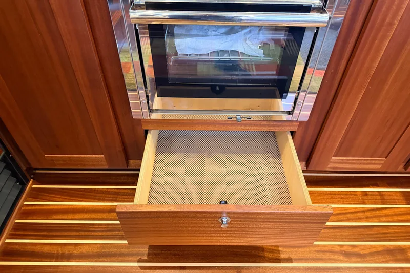 Slide: The Image of Wooden cabinetry with open drawer in 2022 American Tug 365 boat interior. - 12