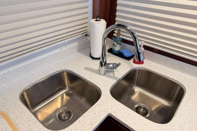 Slide: The Image of Modern kitchen sink with dual basins and chrome faucet on American Tug 365, 2022 model. - 14