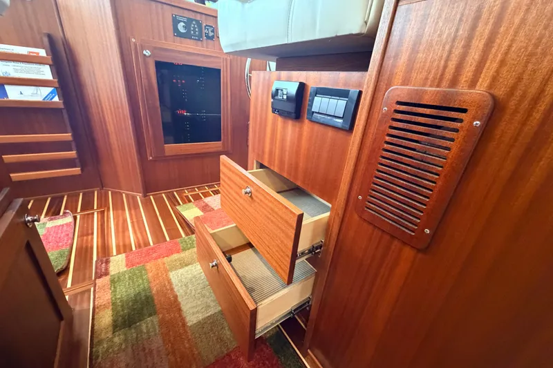 Slide: The Image of Interior of 2022 American Tug 365 with wooden cabinetry and open drawers. - 23