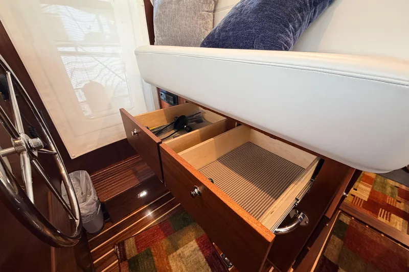 Slide: The Image of Interior of 2022 American Tug 365 with open storage drawers under seating. - 26