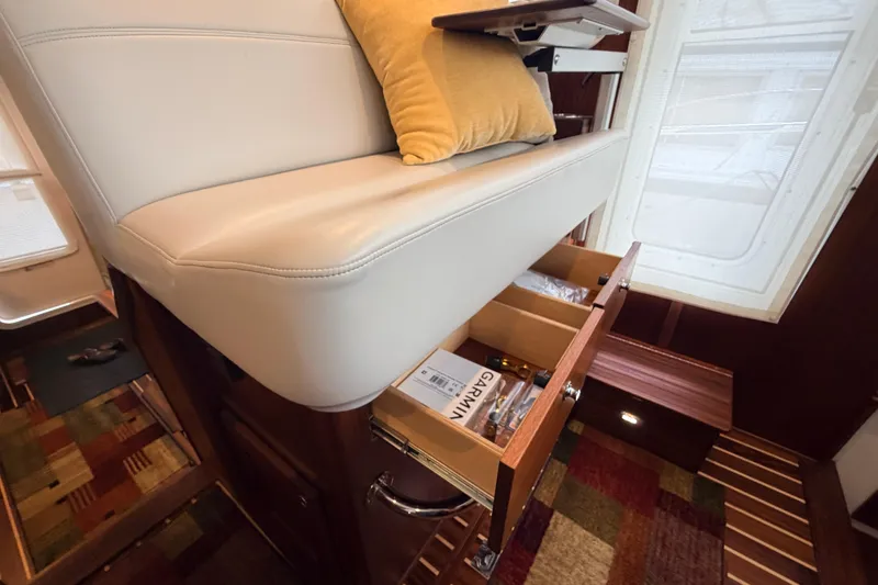 Slide: The Image of Interior of 2022 American Tug 365 with storage drawers and cushioned seating. - 27