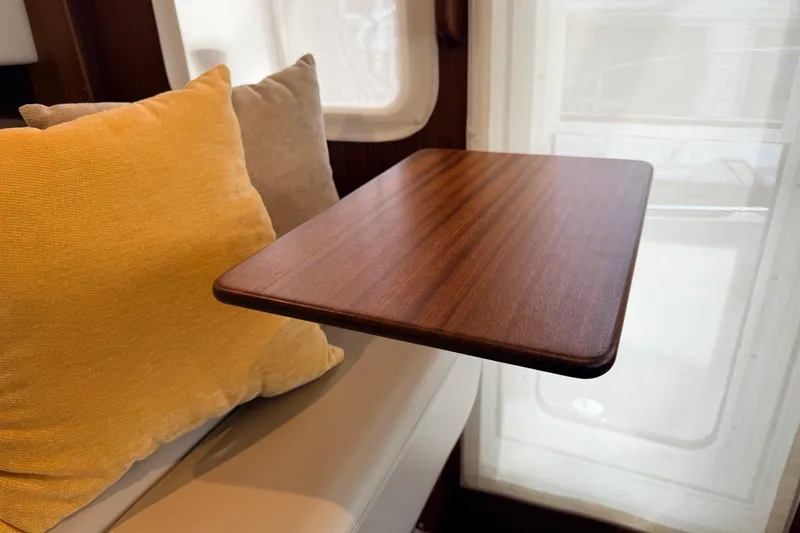 Slide: The Image of Interior of 2022 American Tug 365 with wooden table and colorful cushions. - 28