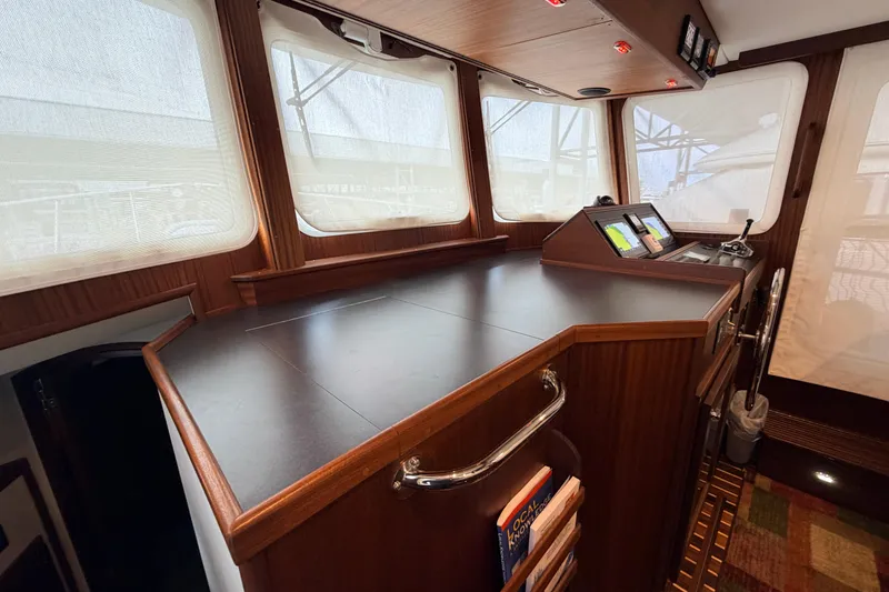 Slide: The Image of Interior helm of 2022 American Tug 365 with navigation equipment and wood finish. - 30
