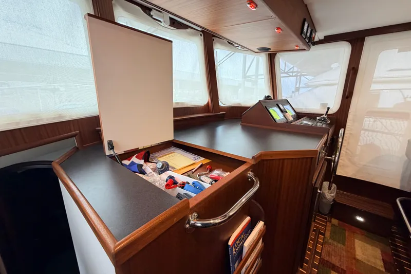 Slide: The Image of Interior of 2022 American Tug 365 with navigation station and storage compartment. - 31
