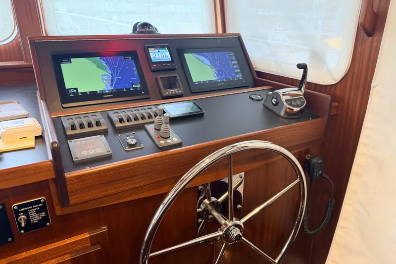 Slide: The Image of Pilothouse of 2022 American Tug 365 with navigation screens and steering wheel. - 33