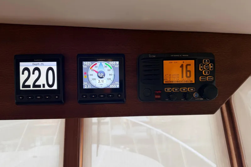 Slide: The Image of American Tug 365 2022 dashboard with Garmin displays and Icom VHF radio. - 36