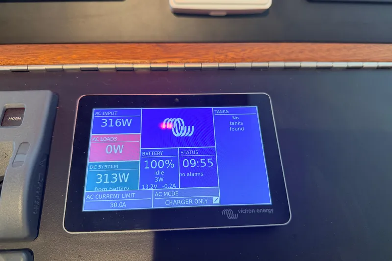 Slide: The Image of Control panel display on a 2022 American Tug 365, showing power and battery status. - 37