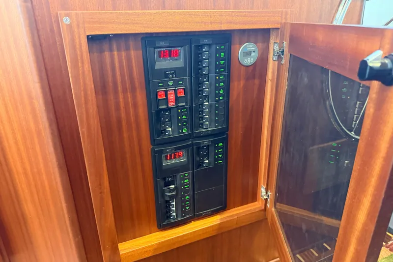 Slide: The Image of Electrical panel inside 2022 American Tug 365 boat, featuring switches and digital displays. - 38