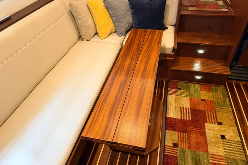 Slide: The Image of Luxurious interior of 2022 American Tug 365 with wooden table, cushions, and colorful carpet. - 4