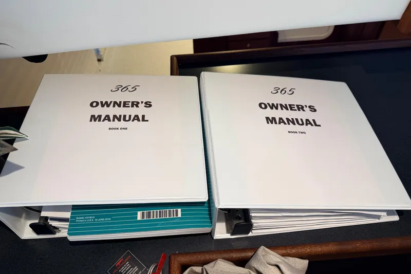Slide: The Image of Owner's manuals for American Tug 365, 2022 model, displayed on a table. - 40