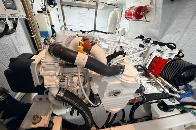 Slide: The Image of Engine room of a 2022 American Tug 365, featuring a Cummins marine engine. - 43