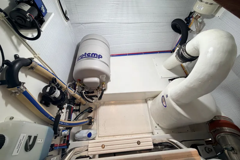 Slide: The Image of Engine room of 2022 American Tug 365 with Votemp water heater and piping system. - 47