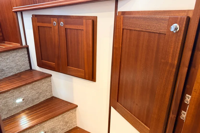 Slide: The Image of Interior of 2022 American Tug 365 with wooden cabinetry and carpeted stairs. - 49