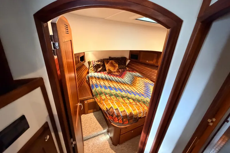 Slide: The Image of Cozy cabin interior of 2022 American Tug 365 with colorful bedding and wooden accents. - 51