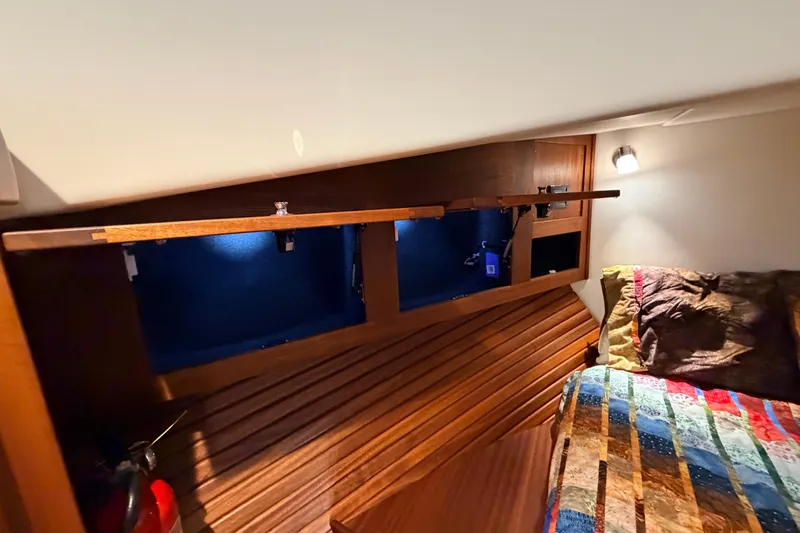 Slide: The Image of Cozy cabin interior of 2022 American Tug 365 with wooden accents and colorful bedding. - 59
