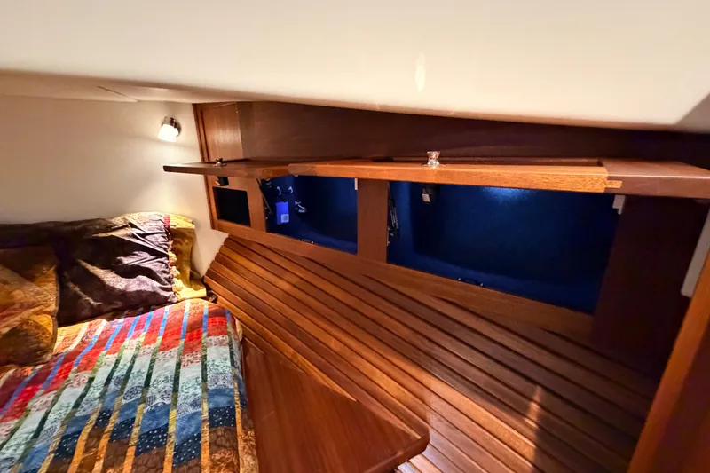 Slide: The Image of Cozy cabin interior of 2022 American Tug 365 with colorful bedding and wooden storage. - 60