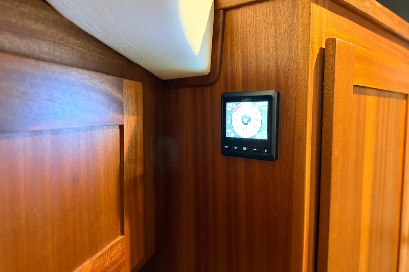 Slide: The Image of Wooden interior of 2022 American Tug 365 with a Garmin display panel. - 61
