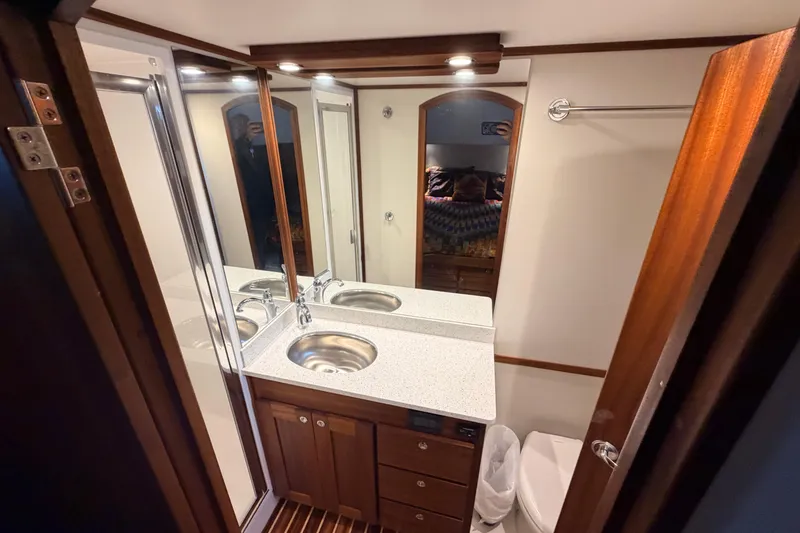 Slide: The Image of Bathroom interior of 2022 American Tug 365 with modern fixtures and wood accents. - 63