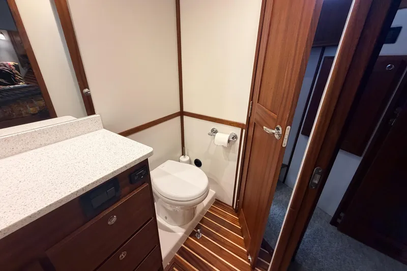 Slide: The Image of 2022 American Tug 365 bathroom with wood accents and modern fixtures. - 64