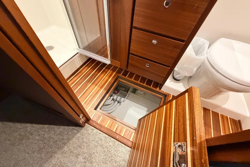 Slide: The Image of Interior of 2022 American Tug 365 bathroom with wooden cabinetry and modern fixtures. - 65