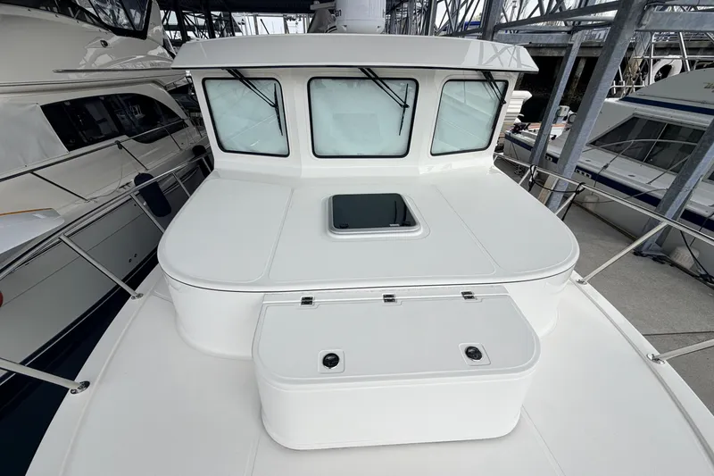 Slide: The Image of 2022 American Tug 365 boat deck with windows and storage compartments. - 69