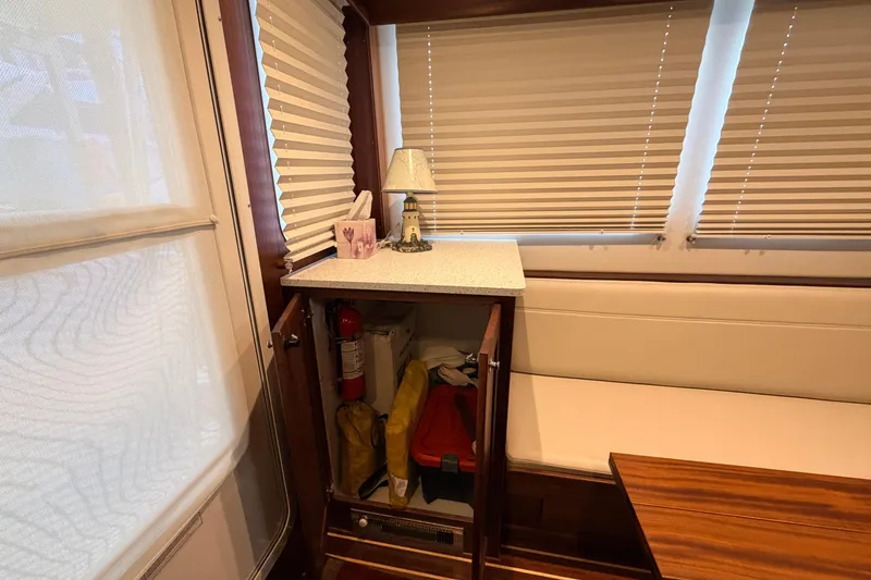 Slide: The Image of Interior of 2022 American Tug 365 with storage cabinet, fire extinguisher, and nautical decor. - 7