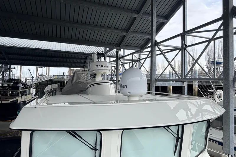 Slide: The Image of 2022 American Tug 365 docked under a metal canopy with navigation equipment. - 70