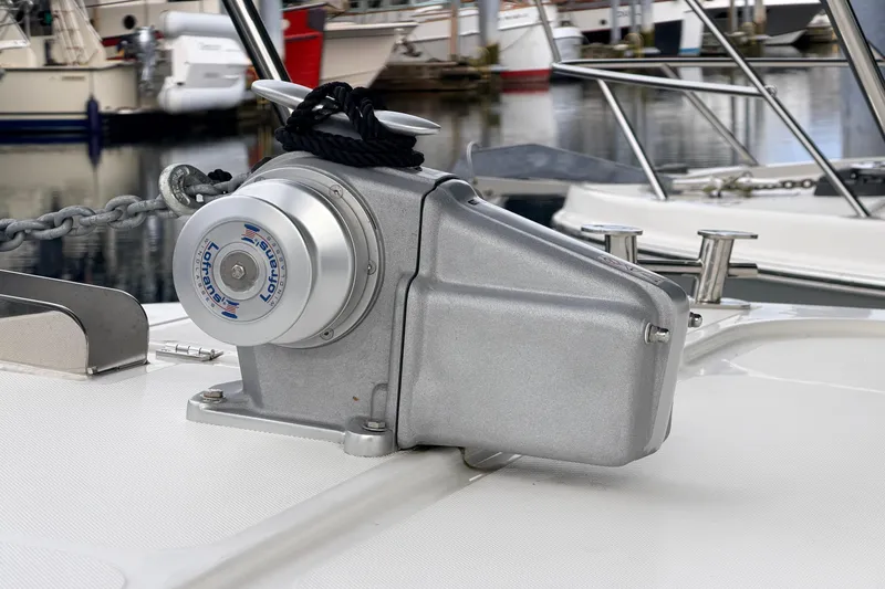 Slide: The Image of Anchor winch on 2022 American Tug 365 boat deck, with marina background. - 73