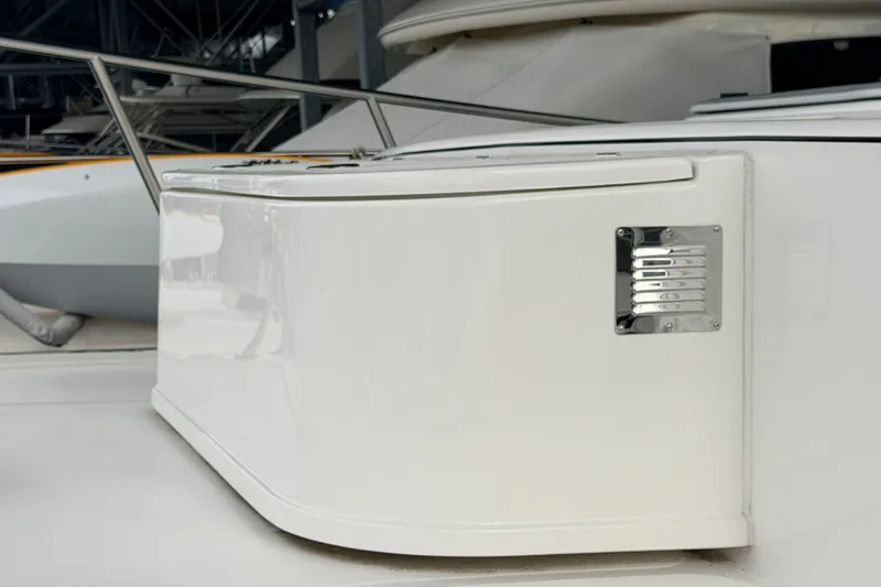 Slide: The Image of American Tug 365 (2022) boat detail with sleek white exterior and metal accents. - 74