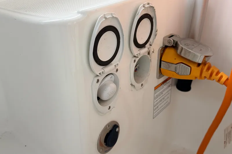 Slide: The Image of Electrical connections on a 2022 American Tug 365 boat, featuring power and utility ports. - 76