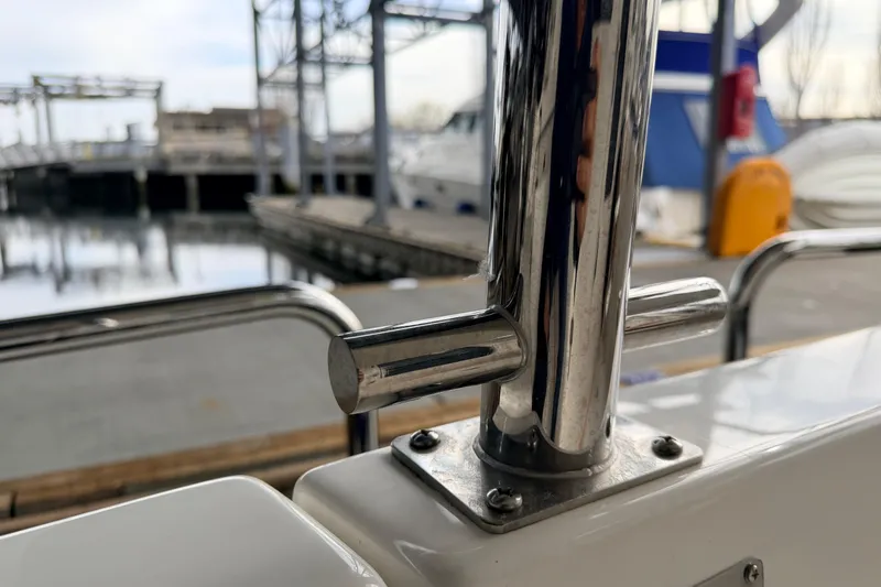 Slide: The Image of Close-up of a 2022 American Tug 365 boat's polished metal railing at a marina. - 78