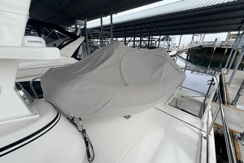 Slide: The Image of Covered boat on American Tug 365, 2022 model, docked under a marina roof. - 87