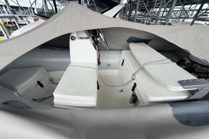 Slide: The Image of Interior view of a 2022 American Tug 365 boat under a protective cover. - 88