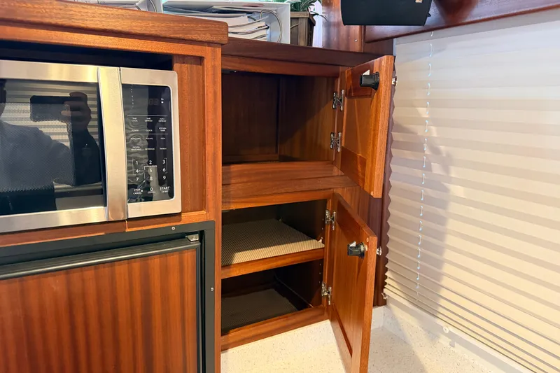 Slide: The Image of Kitchen area of 2022 American Tug 365 with microwave and wooden cabinets. - 9