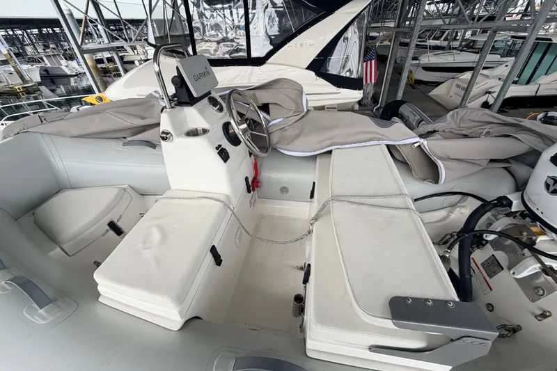 Slide: The Image of Interior view of a 2022 American Tug 365 boat with steering console and seating. - 90
