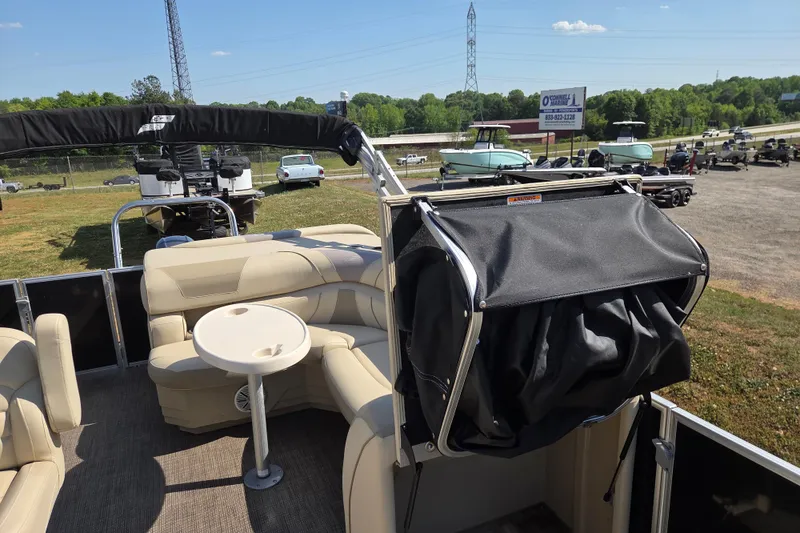 Slide: The Image of 2019 Starcraft EX 20 CF pontoon boat with beige seating and black canopy. - 12