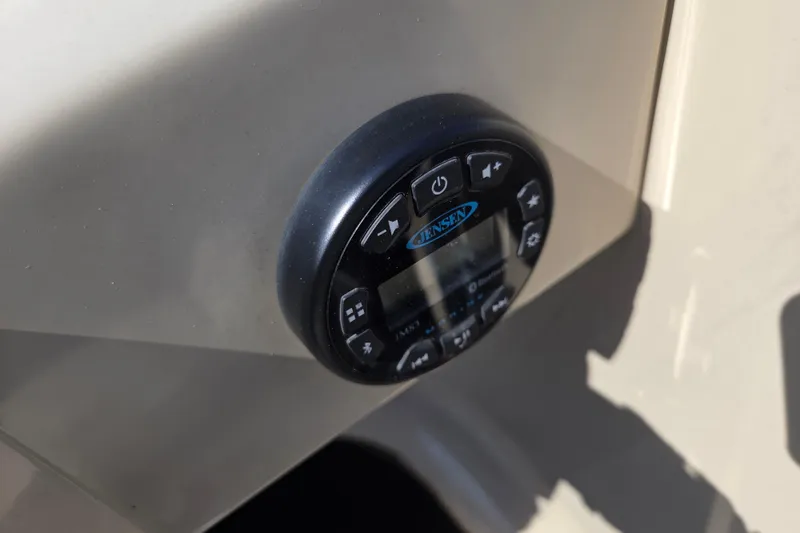 Slide: The Image of Control panel of a 2019 Starcraft EX 20 CF boat featuring Jensen audio system. - 13