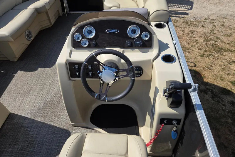 Slide: The Image of 2019 Starcraft EX 20 CF boat dashboard with steering wheel and control panel. - 14